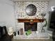 Whitewashed brick fireplace with decorative mantel and clock at 5312 Goddard Ave, Orlando, FL 32810