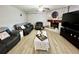 Relaxing living room with dark leather sofas and a fireplace at 5312 Goddard Ave, Orlando, FL 32810