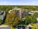 Aerial view of building, showcasing its size, landscaping, and parking at 7662 Whisper Way # 402, Reunion, FL 34747