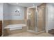 Elegant bathroom with soaking tub and a large walk-in shower at 7662 Whisper Way # 402, Reunion, FL 34747