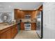Modern kitchen with wood cabinets and granite countertops at 7662 Whisper Way # 402, Reunion, FL 34747