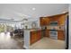 Open kitchen with breakfast bar and stainless steel appliances at 7662 Whisper Way # 402, Reunion, FL 34747