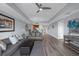Open living room with hardwood floors, a view of the kitchen, and neutral decor at 7662 Whisper Way # 402, Reunion, FL 34747