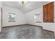 Bedroom with grey tile floors and wooden closet at 965 Keen Rd, Frostproof, FL 33843