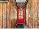 View from inside showing red door and backyard at 965 Keen Rd, Frostproof, FL 33843