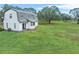 White barn-style home with large backyard and green lawn at 965 Keen Rd, Frostproof, FL 33843