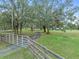 Long driveway leading to house with large oak trees at 965 Keen Rd, Frostproof, FL 33843