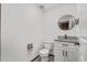 Modern bathroom with granite vanity and a round mirror at 965 Keen Rd, Frostproof, FL 33843