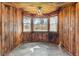 Cozy breakfast nook with wood paneling and large windows at 965 Keen Rd, Frostproof, FL 33843