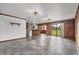Open living area with wood-paneled walls, tile floors, and a view into the kitchen at 965 Keen Rd, Frostproof, FL 33843