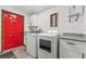Clean laundry room with white cabinets, new appliances and granite countertops at 965 Keen Rd, Frostproof, FL 33843