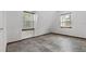 Upstairs bedroom with sloped ceilings, tile floors, and two windows at 965 Keen Rd, Frostproof, FL 33843