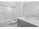 Clean bathroom featuring a bathtub, toilet and gray vanity at 3550 Davenport Creek Ct, Kissimmee, FL 34746