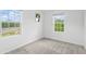 Well-lit bedroom with two large windows and carpeted floor at 3550 Davenport Creek Ct, Kissimmee, FL 34746