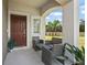 Front porch with seating area, welcoming entryway at 3550 Davenport Creek Ct, Kissimmee, FL 34746