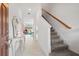 Elegant entryway with staircase and decorative console table at 3550 Davenport Creek Ct, Kissimmee, FL 34746