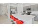 Modern kitchen with gray cabinets, white countertops, and red barstools at 3550 Davenport Creek Ct, Kissimmee, FL 34746