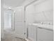 Laundry room with washer, dryer, and overhead shelving at 3550 Davenport Creek Ct, Kissimmee, FL 34746