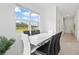 Bright dining room with modern white table and black chairs at 3550 Davenport Creek Ct, Kissimmee, FL 34746