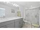 Modern bathroom with double vanity, shower, and gray cabinets at 3550 Davenport Creek Ct, Kissimmee, FL 34746