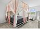 Spacious bedroom with canopy bed and en-suite bathroom at 3550 Davenport Creek Ct, Kissimmee, FL 34746