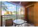 Private screened patio with table and chairs, overlooking a parking lot at 12527 Floridays Resort Dr # E-103, Orlando, FL 32821
