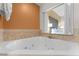 Relaxing corner bathtub with jets and bedroom view at 12527 Floridays Resort Dr # E-103, Orlando, FL 32821
