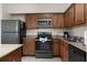 Well-equipped kitchen, granite counters, and stainless steel appliances at 12527 Floridays Resort Dr # E-103, Orlando, FL 32821