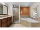 Bathroom with a large soaking tub and walk-in shower at 12527 Floridays Resort Dr # E-103, Orlando, FL 32821