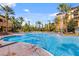 Inviting resort-style pool with palm trees and lounge chairs at 12527 Floridays Resort Dr # E-103, Orlando, FL 32821