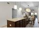 Kitchen island with granite top, offering extra prep and seating space at 12527 Floridays Resort Dr # E-103, Orlando, FL 32821