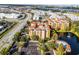Aerial view highlighting building location near a lake at 12527 Floridays Resort Dr # E-103, Orlando, FL 32821