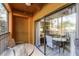Screened patio with table and chairs and view of living room at 12527 Floridays Resort Dr # E-103, Orlando, FL 32821