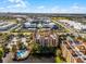 Aerial view of resort community with pool, lake, and multiple buildings at 12527 Floridays Resort Dr # E-103, Orlando, FL 32821