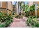 Courtyard with lush landscaping and walkways between buildings at 12527 Floridays Resort Dr # E-103, Orlando, FL 32821