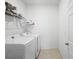 Laundry room with washer, dryer, and shelving at 15109 Willow Arbor Cir, Orlando, FL 32824