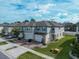 Two-story townhome with attached garage and manicured lawn at 15109 Willow Arbor Cir, Orlando, FL 32824