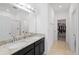 Bathroom with double sinks, granite countertops, and walk-in closet at 15109 Willow Arbor Cir, Orlando, FL 32824