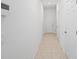 Long hallway with tile floors and access to other rooms at 15109 Willow Arbor Cir, Orlando, FL 32824