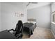 Bedroom with a bed, desk, chair, and wall art at 15109 Willow Arbor Cir, Orlando, FL 32824