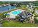Community pool with a clubhouse and lounge chairs at 15109 Willow Arbor Cir, Orlando, FL 32824