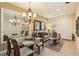 Bright dining area with glass table and chandelier, adjacent to living room at 3408 Allegra Cir, Saint Cloud, FL 34772