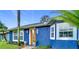 Charming blue house with modern front door and lush landscaping at 4344 Ilene Ct, Orlando, FL 32806