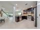 Modern kitchen featuring dark cabinetry, stainless steel appliances, and granite countertops at 5249 Villa Rosa Ave, St Cloud, FL 34771