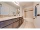 Bathroom with granite countertop, dark brown vanity, and a bathtub at 5249 Villa Rosa Ave, St Cloud, FL 34771