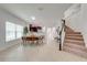 Open concept dining area with kitchen views and staircase in the background at 5249 Villa Rosa Ave, St Cloud, FL 34771