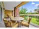 Private balcony with outdoor seating and a view of lush greenery at 7650 Whisper Way # 203, Reunion, FL 34747