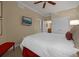 Spacious bedroom with a king-size bed, ceiling fan, and ample closet space at 7650 Whisper Way # 203, Reunion, FL 34747