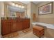 Double vanity bathroom with soaking tub and separate shower at 7650 Whisper Way # 203, Reunion, FL 34747