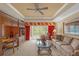 Bright living room featuring a built-in workspace and balcony access at 7650 Whisper Way # 203, Reunion, FL 34747